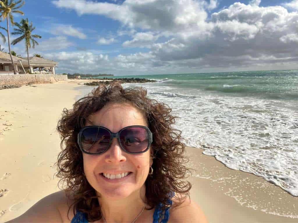 selfie on sands of beach with palm trees and surf
