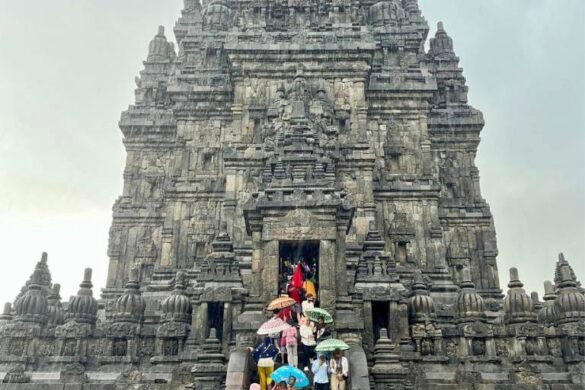 Prambanan Temple with umbrellas in the rain People with umbrellas at Prambanan Temple