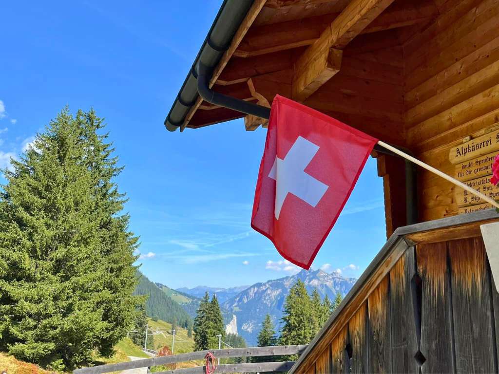 swiss flag hanging from chalet