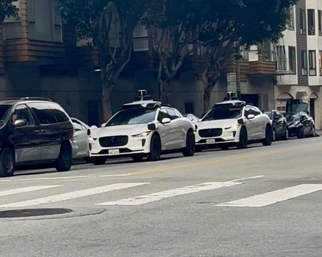 Two waymo cars