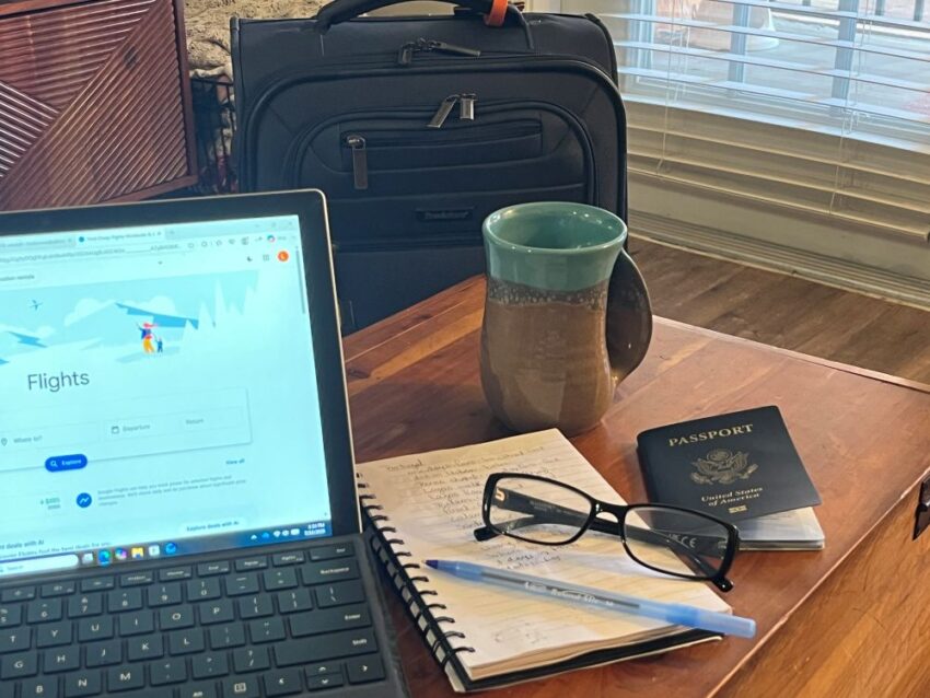 Laptop with passport and notes