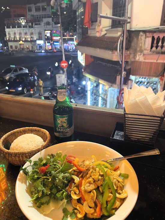 Cashew chicken and Huda beer overlooking an Old Quarter street at Hanoi Square Restaurant