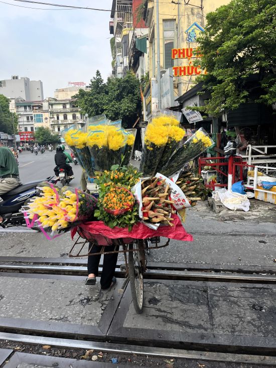 Bicycle loaded with colorful flowers on a Hanoi street