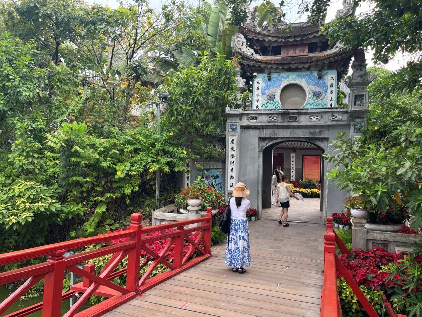 Red Thê Húc Bridge leading to Ngoc Son Temple at Hoan Kiem Lake in Hanoi