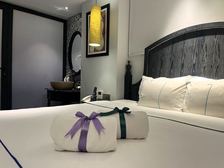Bed with towel decorations at Emerald Waters Valley Hotel in Hanoi