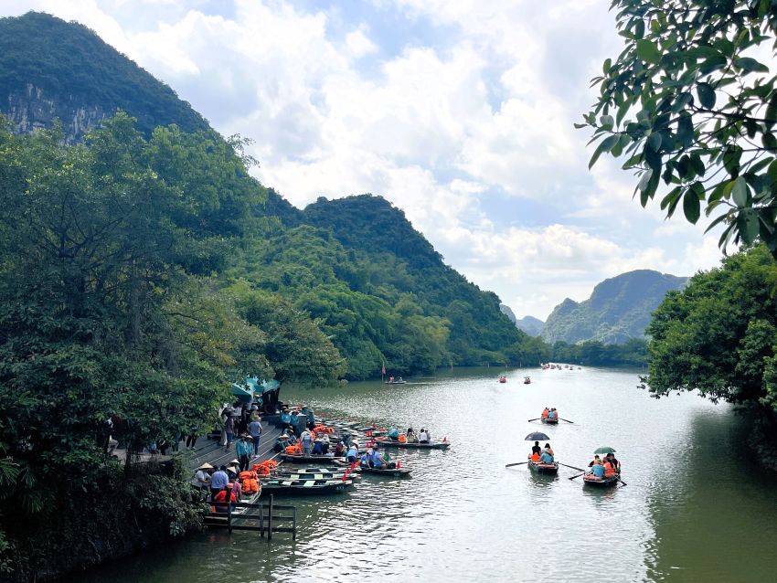 Trang An boats on river with mountains