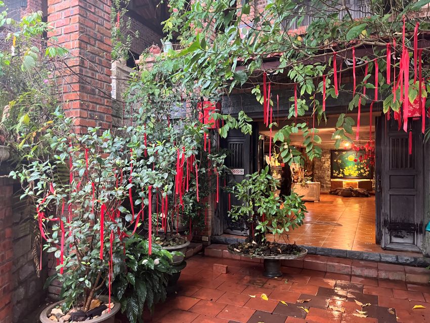 Lush courtyard entrance at Hien Tra Nhi Do Mai tea house in Hue